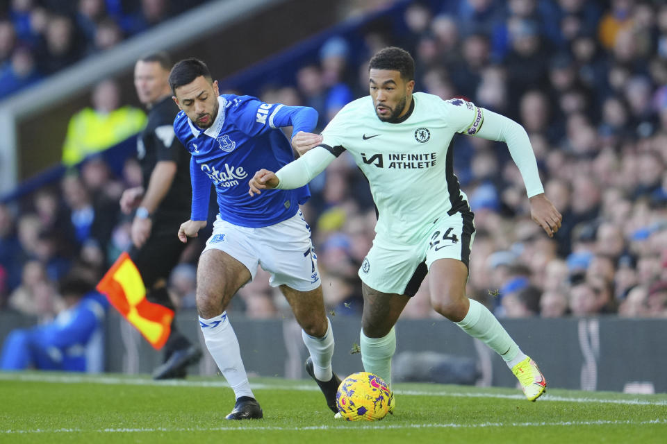 Everton's Dwight McNeil, left, challenges for the ball with Chelsea's Reece James during the English Premier League soccer match between Everton and Chelsea, at Goodison Park Stadium, in Liverpool, England, Sunday, Dec.10, 2023. (AP Photo/Jon Super)