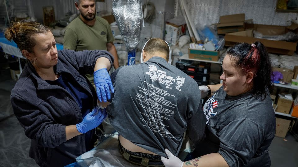 Medics prepare for transportation of a wounded Ukrainian serviceman inside a medical stabilization point near Chasiv Yar on July 1, 2024. - Alina Smutko/Reuters