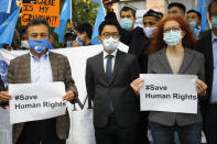 Hong Kong activist Nathan Law, center, takes part in a protest during the visit of Chinese Foreign Minister Wang Yi in Berlin, Germany, Tuesday, Sept. 1, 2020. German Foreign Minister Heiko Maas meets his Chinese counterpart at the foreign ministry guest house Villa Borsig for bilateral talks. (AP Photo/Markus Schreiber)