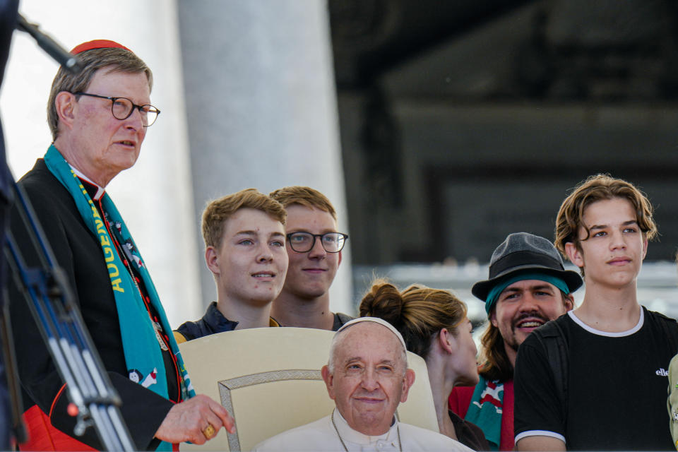 FILE - Cardinal Rainer Maria Woelki, left, talks to Pope Francis during his weekly general audience in St. Peter's Square at The Vatican, Oct. 5, 2022. Catholic in the Archdiocese of Cologne believers in Cologne have protested their deeply divisive bishop and are leaving in droves over allegations that he may have covered up clergy sexual abuse reports. In the latest escalation of the crisis, Cologne prosecutors have opened an investigation against Cardinal Rainer Maria Woelki in two cases on suspicion of making false affidavits. (AP Photo/Alessandra Tarantino, File)