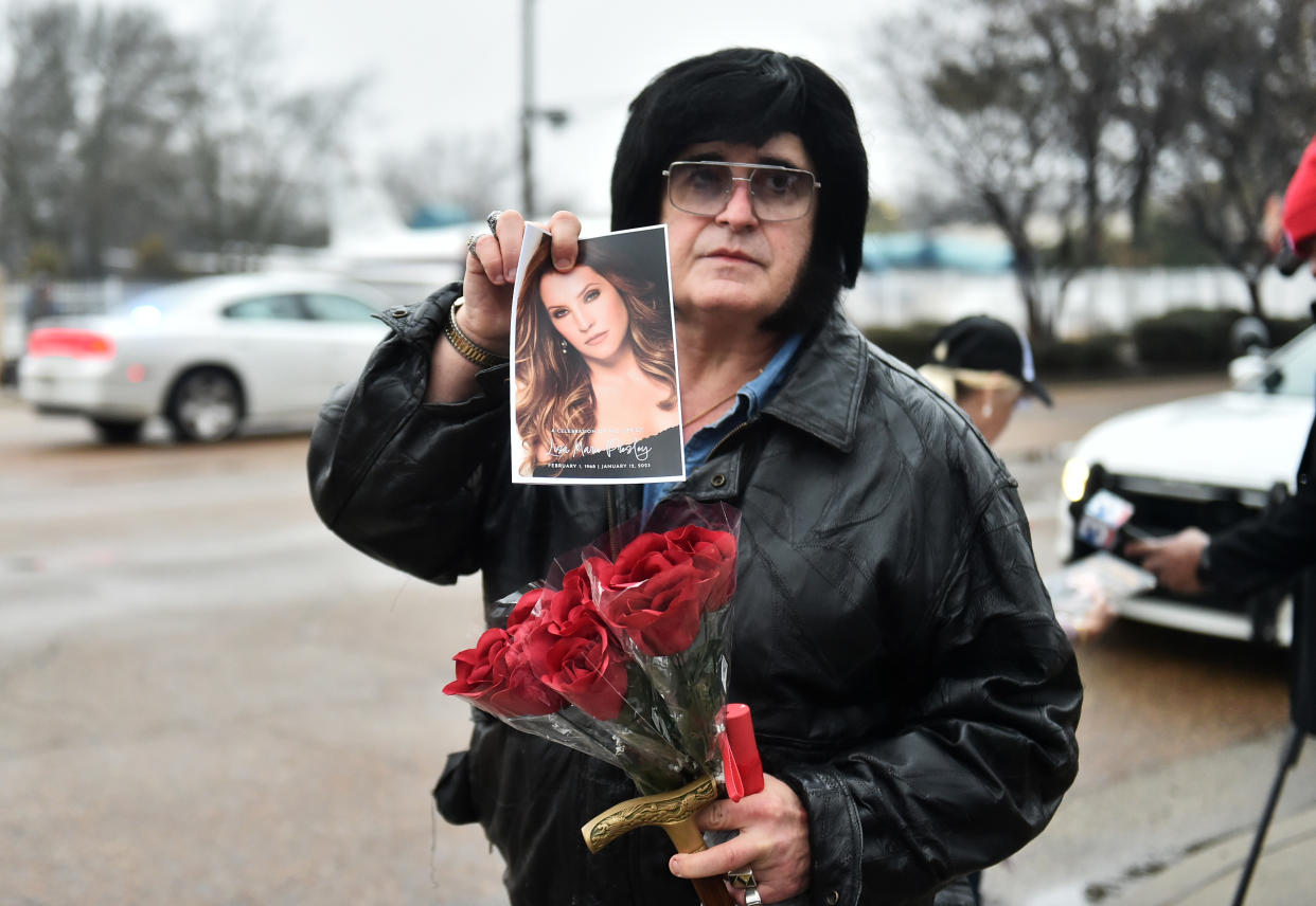 A fan gathers to pay respects at the memorial for Lisa Marie Presley.