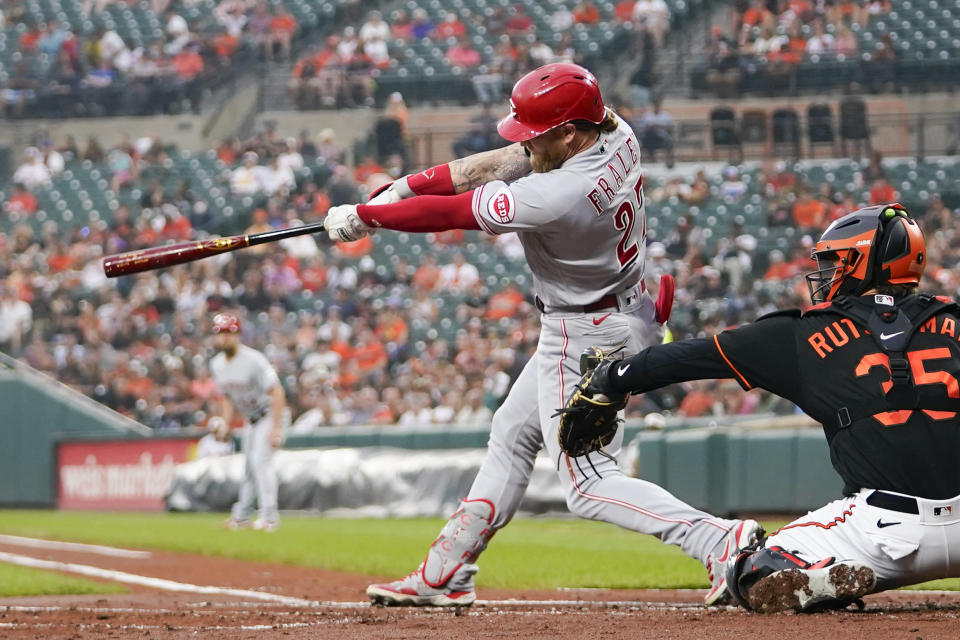 Cincinnati Reds' Jake Fraley hits an RBI single to score Jonathan India in the first inning of a baseball game against the Baltimore Orioles, Wednesday, June 28, 2023, in Baltimore. (AP Photo/Julio Cortez)