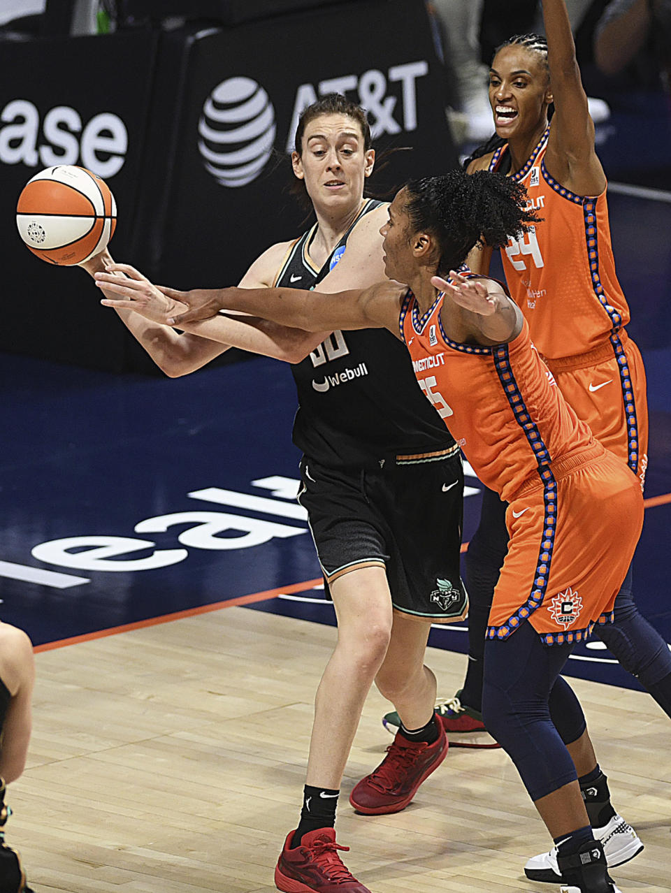 New York Liberty's Breanna Stewart (30) is guarded by Connecticut Sun's Alyssa Thomas (25) and DeWanna Bonner (24) during a WNBA basketball game Thursday, Aug. 24, 2023, in Uncasville, Conn. (Sarah Gordon/The Day via AP)