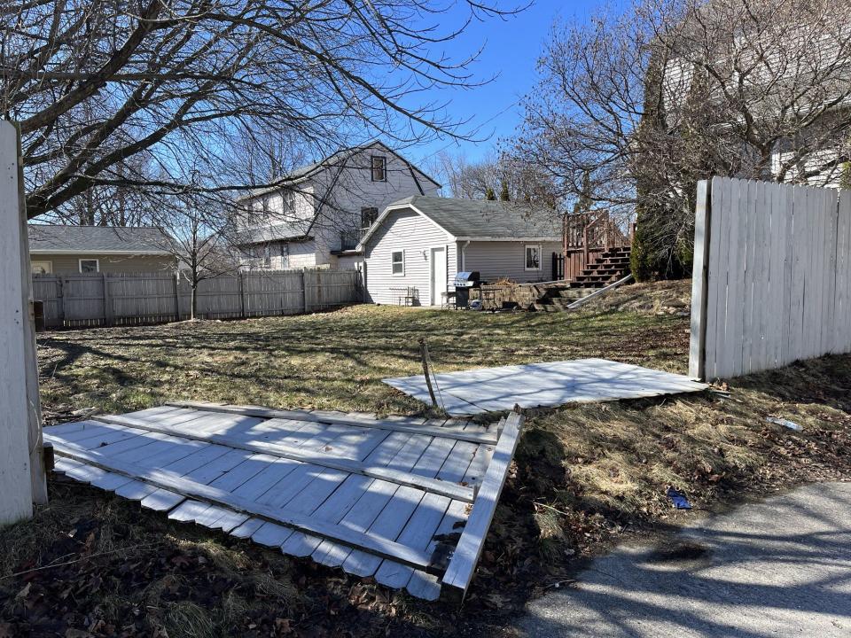 A broken fence in the backyard of the home on the 2700 block of S. Ninth Street, as seen, Friday, March 15, in Sheboygan, Wis.