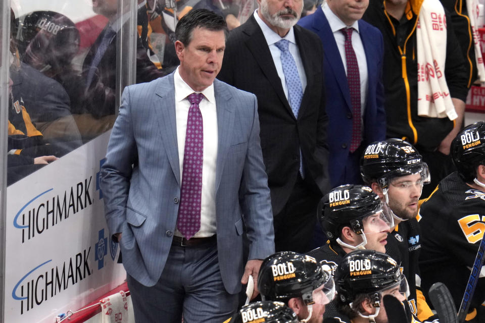 Pittsburgh Penguins head coach Mike Sullivan, left, stands behind his bench during the first period of an NHL hockey game against the Washington Capitals in Pittsburgh, Thursday, March 7, 2024. The Capitals won 6-0. (AP Photo/Gene J. Puskar)