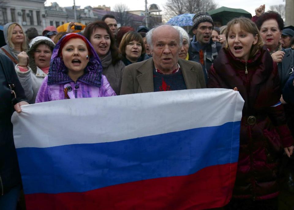 In this photo taken Wednesday, March 5, 2014, pro-Russian supporters chant slogans during a rally at a central square in Simferopol, Ukraine. Ukraine is facing a potentially crippling geographic and cultural divide, a growing gulf between supporters of Russia who dominate the east and south of the country, and western Ukrainians who yearn for closer ties to Western Europe. One side of that divide is even starker in Crimea, a Black Sea peninsula. For much of the past 200 years, Crimea was under Russian and Soviet control, and today most Crimeans see themselves as only nominally Ukrainian and Russian is, by far, the dominant language (AP Photo/Sergei Grits)