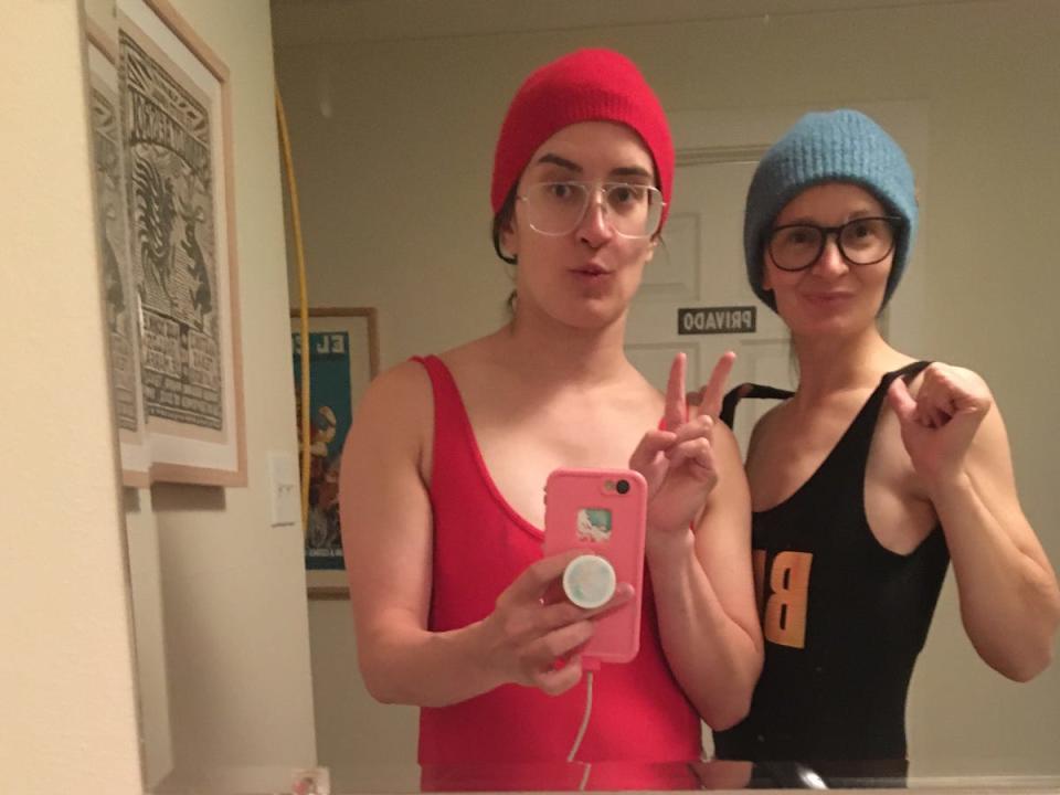 A mirror selfie of the author and a friend wearing beanies and bathing suits.