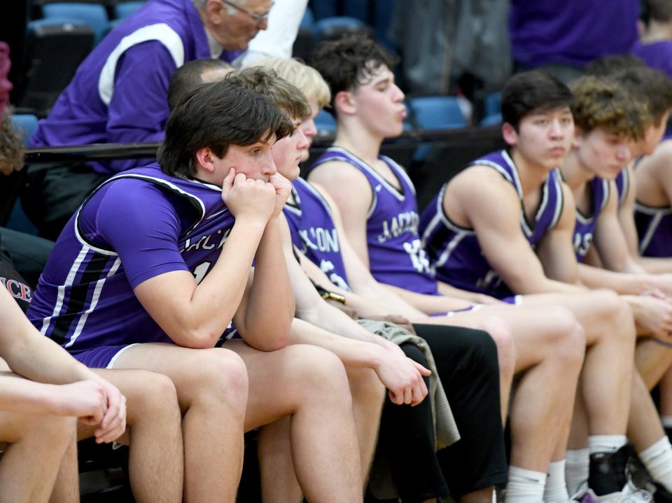 Jackson boys sit on the bench after a loss to Stow in the Division I district final Saturday, March 4, 2023, at Alliance High School.