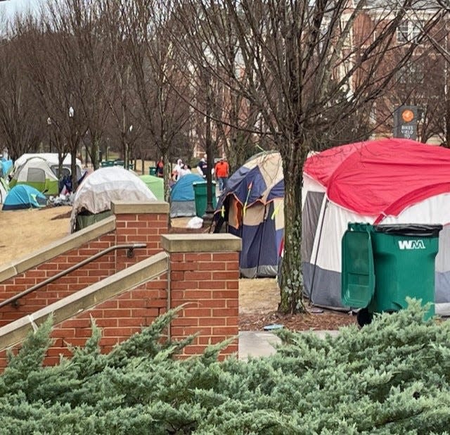 Tents where students camped out for seating at Auburn's home basketball game against Alabama line a path adjacent to Neville Arena.
