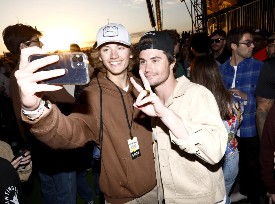 Chase Stokes (R) and guest attend Poguelandia: An Outer Banks Experience on February 18, 2023 in Huntington Beach, California. (Photo by Emma McIntyre/Getty Images for Netflix)