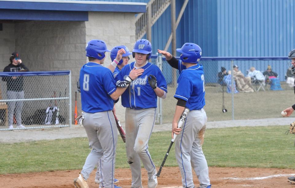 Wynford's Dylon Robinson is congratulated by his teammates after a three-run home run.