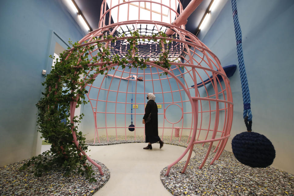 A woman visits Great Britain's pavilion during a press preview of the exhibition "How will we live together?", at the Biennale International Architecture, in Venice, Italy Thursday, May 20, 2021. The 17th International Architecture Exhibition opens Saturday after a one-year pandemic delay, during which time architecture has emerged as one of the key disciplines in the global coronavirus response. (AP Photo/Alessandra Tarantino)