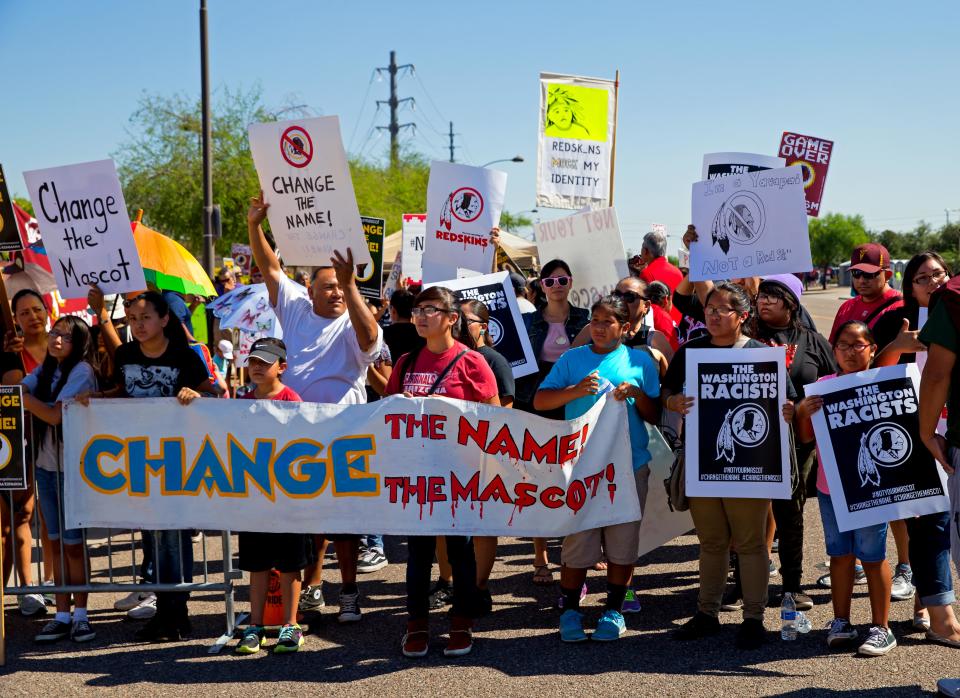 Groups protest the Washington NFL team's game in 2014.