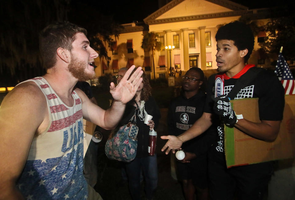 Donald Trump supporter Ben Kilgore, (L), discusses the president-elect's merits with protester Brandon Nathaniel Collier, who is demonstrates against Trump's election as President of the United States, in Tallahassee, Fla., on Nov. 16, 2016. REUTERS/Phil Sears/Reuters)