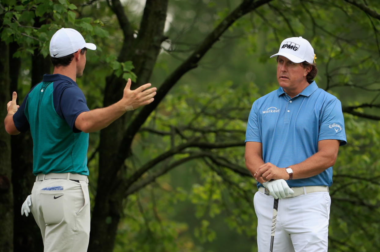 ST. LOUIS, MO - AUGUST 07:  (L-R) Rory McIlroy of Northern Ireland and Phil Mickelson of the United States talk on the second tee during a practice round prior to the 2018 PGA Championship at Bellerive Country Club on August 7, 2018 in St. Louis, Missouri.  (Photo by Jamie Squire/Getty Images)