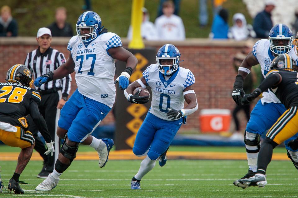 Nov 5, 2022; Columbia, Missouri, USA; Kentucky Wildcats running back Kavosiey Smoke (0) looks for an opening during the third quarter against the Missouri Tigers at Faurot Field at Memorial Stadium. Mandatory Credit: William Purnell-USA TODAY Sports