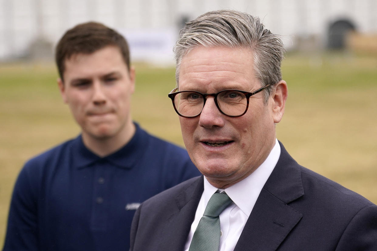 Britain's Prime Minister Keir Starmer (C) speaks with Airbus employees as he visits the company's stand on the opening day of the Farnborough International Airshow 2024, south west of London, on July 22, 2024. (Photo by Alberto Pezzali / POOL / AFP) (Photo by ALBERTO PEZZALI/POOL/AFP via Getty Images)