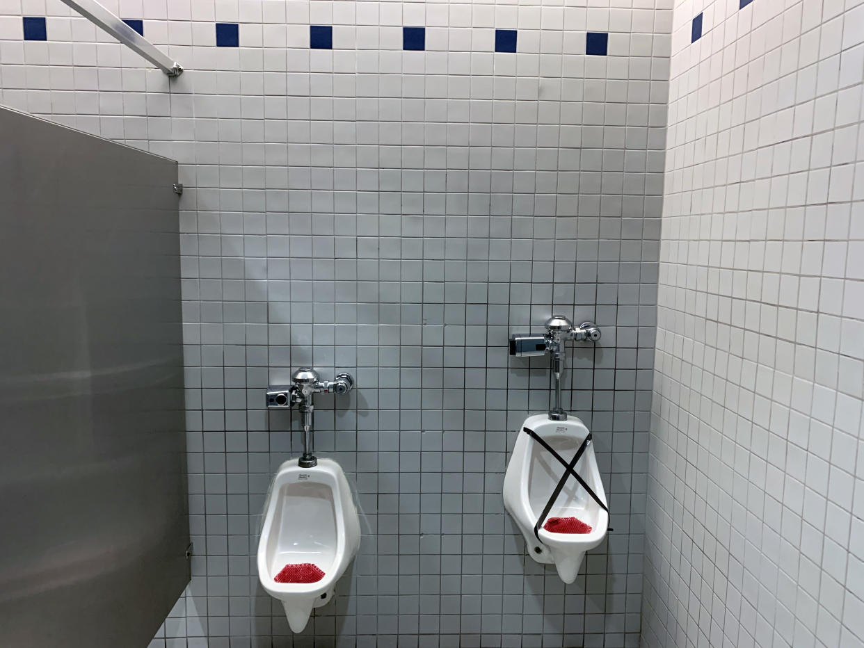 DALLAS, TEXAS - MAY 01:  A urinal in the men's restroom is taped off in an effort to adhere social distancing guidelines at Allen Premium Outlets during the coronavirus (COVID-19) pandemic on May 01, 2020 in Allen, Texas.  Texas. Gov. Abbott announced the reopening of retail stores, restaurants, movie theaters and malls at 25% capacity beginning on May 1, 2020.  (Photo by Ronald Martinez/Getty Images)