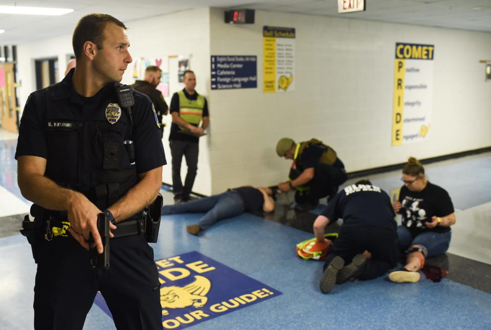 First responders and school officials during an active shooter training exercise on Wednesday, Aug. 17, 2022, at Grand Ledge High School. Students and teachers volunteered to act as victims with fake wounds and blood from the staged mock mass shooting.
