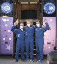 In this photo released by the Roscosmos Space Agency, from left, U.S. astronaut Mark Vande Hei, Russian cosmonauts Oleg Novitsky and Pyotr Dubrov, members of the main crew to the International Space Station (ISS), waves near a bus with portraits of the first cosmonaut Yuri Gagarin prior to the launch at the Russian leased Baikonur cosmodrome, Kazakhstan, Friday, April 9, 2021. A Russian-U.S. trio of space travelers have launched successfully, heading for the International Space Station. NASA astronaut Mark Vande Hei and Russian cosmonauts Oleg Novitskiy and Pyotr Dubrov blasted off as scheduled at 12:42 p.m. (0742 GMT, 3:42 a.m. EDT) Friday aboard the Soyuz MS-18 spacecraft from the Russia-leased Baikonur launch facility in Kazakhstan. (Roscosmos Space Agency via AP)