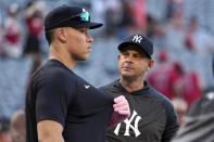 New York Yankees' Aaron Judge, left, talks with manager Aaron Boone stands by prior to a baseball game against the Los Angeles Angels Tuesday, July 18, 2023, in Anaheim, Calif. (AP Photo/Mark J. Terrill)