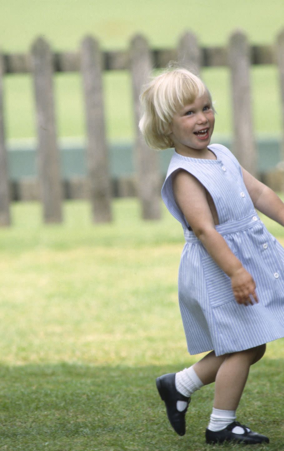 <p>The three-year-old knew how to work the cameras early on. She flashes a smile at photographers, while cheering on her uncle at a polo match in Windsor.</p>