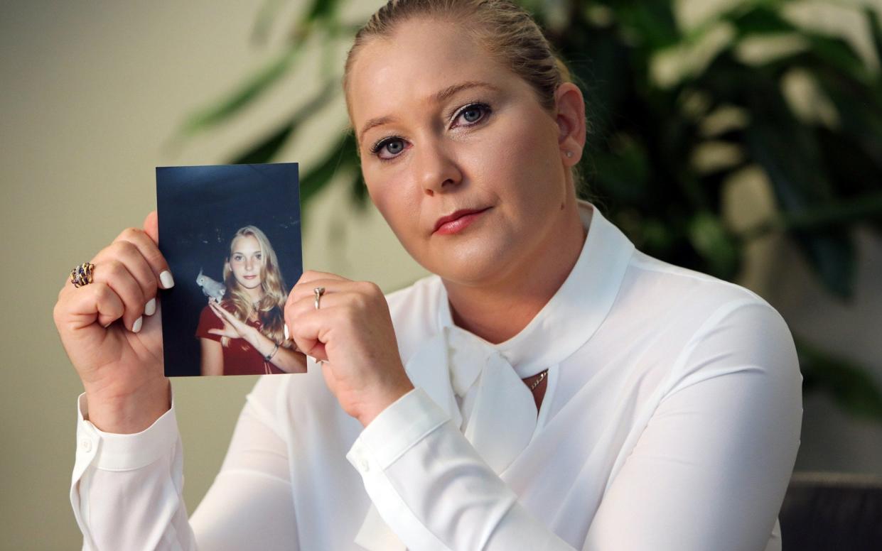 Virginia Roberts, seen holding a photo of herself at age 16 - Tribune News Service/Getty Images