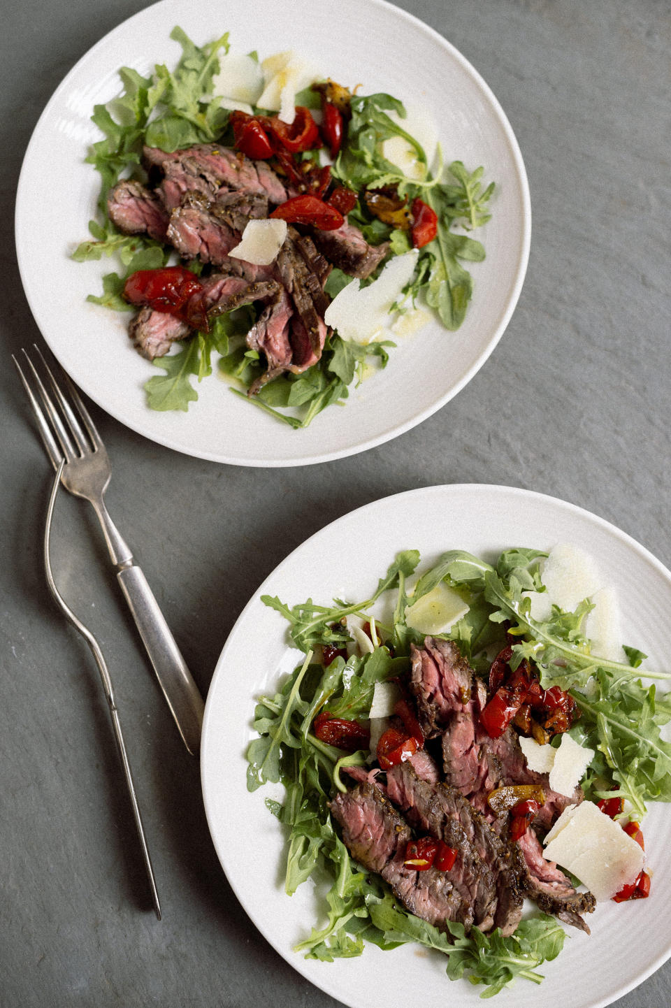 This image released by Milk Street shows a recipe for skirt steak salad with arugula and Peppadew peppers. (Milk Street via AP)