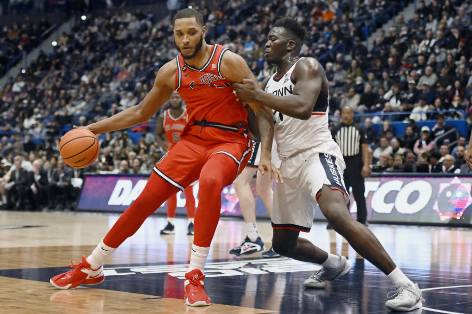 UConn's Adama Sanogo, right, fouls St. John's Joel Soriano in the second half of an NCAA college basketball game, Sunday, Jan. 15, 2023, in Hartford, Conn. (AP Photo/Jessica Hill)