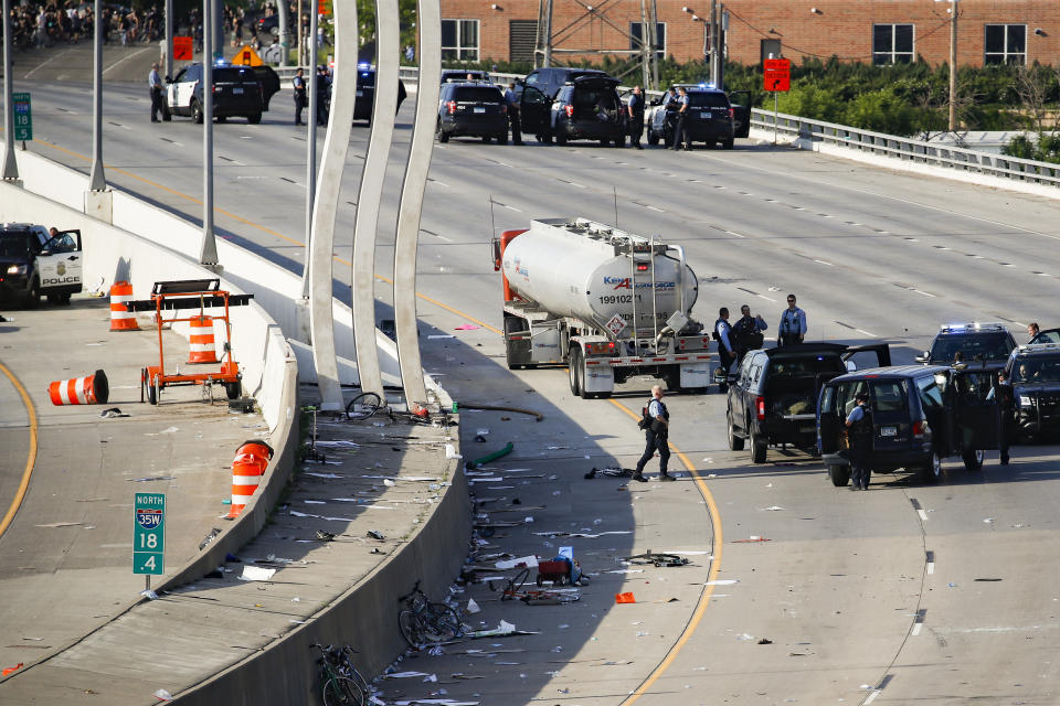 A semi-truck involved in an incident with protesters on Highway 35W is surrounded by authorities, Sunday, May 31, 2020, in St. Paul, Minn. Protests continued following the death of George Floyd, who died after being restrained by Minneapolis police officers on Memorial Day. (AP Photo/John Minchillo)