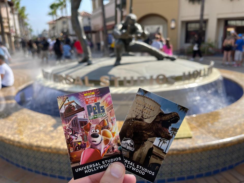 hand holding two paper universal tickets at universal hollywood