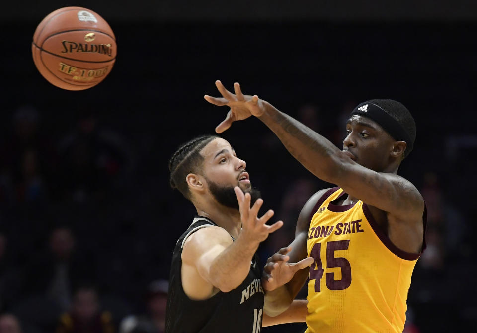 Arizona State forward Zylan Cheatham, right, passes the ball while under pressure from Nevada forward Caleb Martin during the first half of an NCAA college basketball game at the Basketball Hall of Fame on Classic Friday, Dec. 7, 2018, in Los Angeles. (AP Photo/Mark J. Terrill)