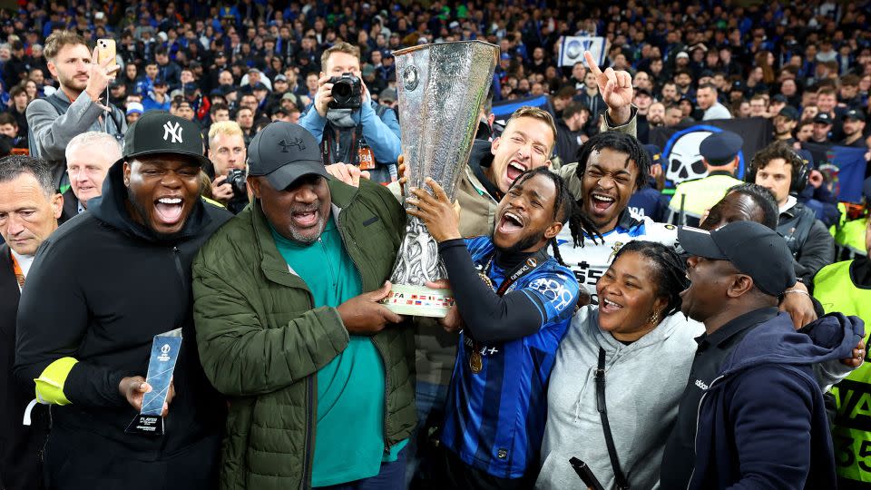 Lookman celebrates with the Europa League trophy. - Paul Childs/Reuters