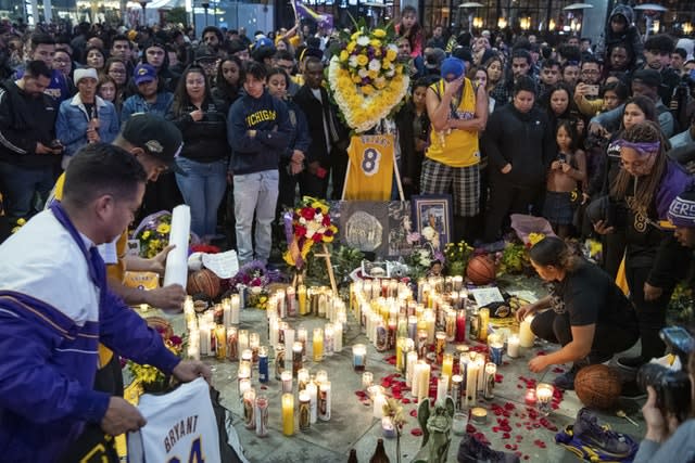 Fans pay tribute at a memorial near Staples Center in Los Angeles