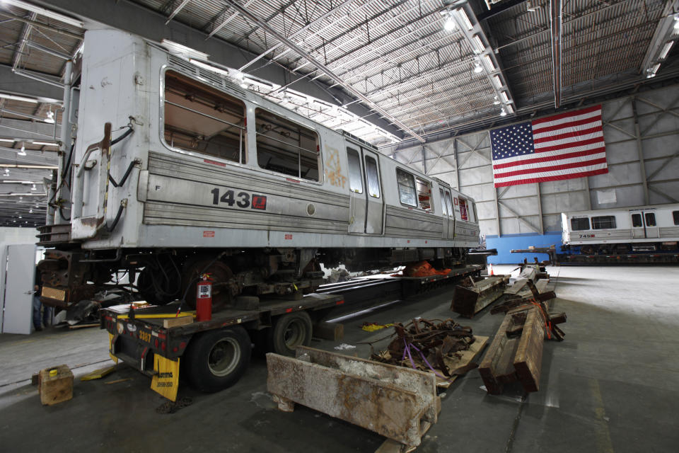 Two PATH subway cars sits inside Hangar 17 at New York's John F. Kennedy International Airport June 16, 2011. A program operated by the Port Authority of New York and New Jersey, The World Trade Center steel program, is selecting portions of the steel recovered from the Center and donating it to cities, towns, firehouses and museums around the U.S. and the world who request it for use in 911 memorial sites in time for the 10 year anniversary of the 2001 attacks. Picture taken June 16, 2011. (REUTERS/Mike Segar)