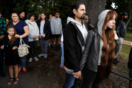 People react near Masjid Al Noor mosque in Christchurch, New Zealand, March 17, 2019. REUTERS/Jorge Silva