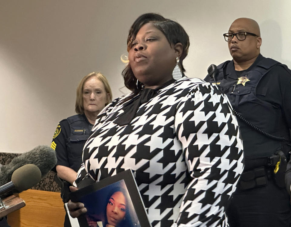 Stephanie Houston holds a photo of her daughter Muhlaysia Booker as she speaks to reporters on Thursday, Nov. 9, 2023, after giving a victim impact statement in a courtroom at the Frank Crowley Courts Building in Dallas. On Monday, Nov. 6, Kendrell Lyles pleaded guilty to murder in the death of Booker, a 22-year-old transgender woman who was fatally shot in 2019. Lyles was sentenced to 48 years in prison. (AP Photo/Jamie Stengle)