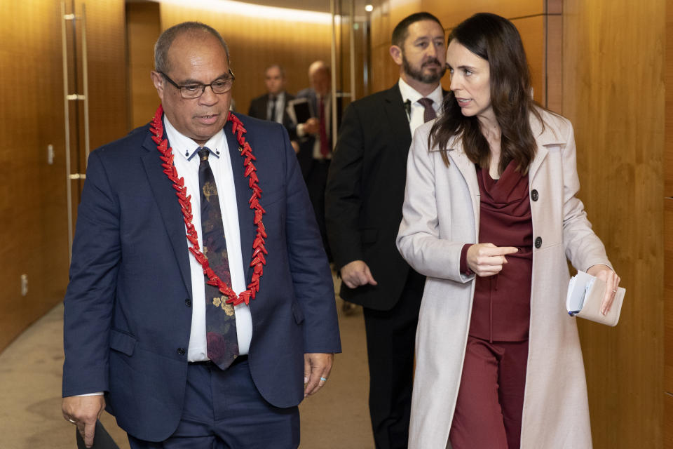 Pacific Peoples Minister Aupito William Sio, left, and Prime Minister Jacinda Ardern arrive for a post-Cabinet press conference at Parliament in Wellington, New Zealand, Monday, June 14, 2021. New Zealand's government is formally apologizing for an immigration crackdown nearly 50 years ago in which Pacific people were targeted for deportation, often after early-morning home raids. (Mark Mitchell/NZ Herald via AP)