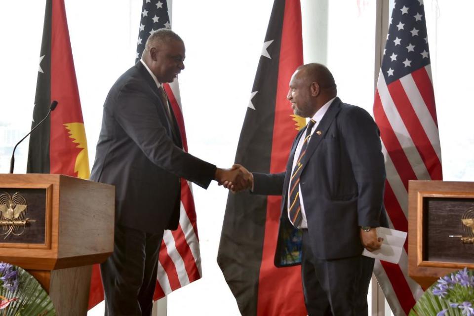 James Marape shakes hands with US secretary of defense Lloyd Austin in Port Moresby.