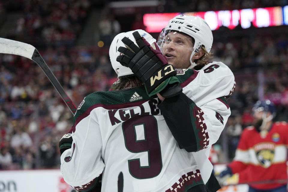 Arizona Coyotes defenseman Jakob Chychrun (6) celebrates with right wing Clayton Keller (9) after Chychrun scored a goal during the first period of an NHL hockey game against the Florida Panthers, Tuesday, Jan. 3, 2023, in Sunrise, Fla. (AP Photo/Wilfredo Lee)