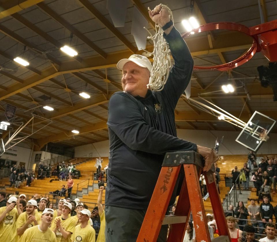 Coach Jeff Santarsiero was all smiles after cutting down the net following Geneva's win in the Presidents' Athletic Conference championship game.
