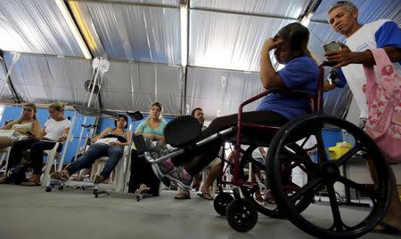 Patients are administered drips as they await the results of their dengue examination, in a medical tent in Rio Claro, Brazil March 5, 2015. REUTERS/Paulo Whitaker