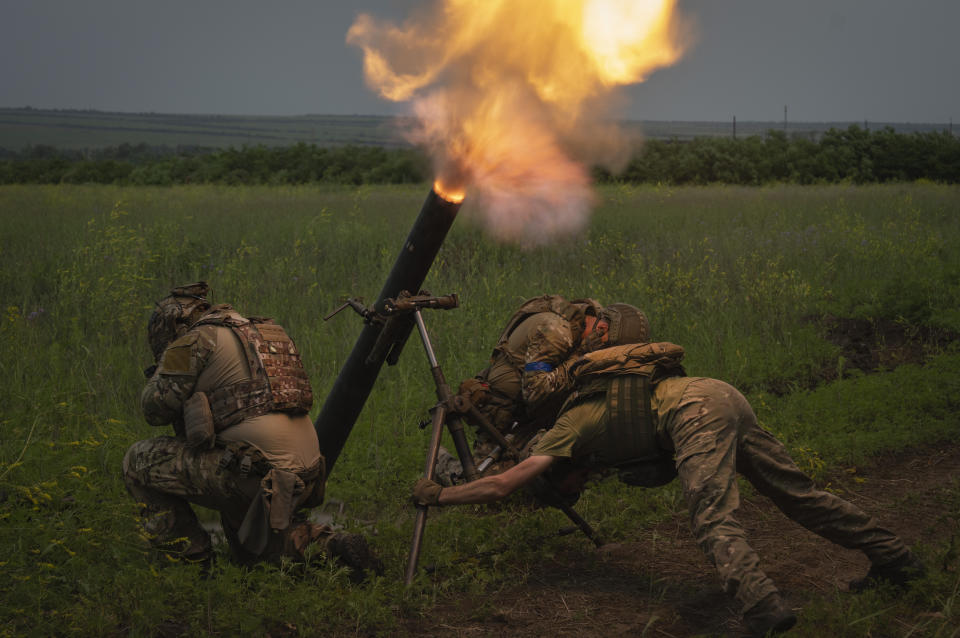 FILE - Ukrainian soldiers fire toward Russian position on the frontline in Zaporizhzhia region, Ukraine, Saturday, June 24, 2023. In the southeastern Zaporizhzhia region, Ukrainian troops - backed by tanks, artillery and drones - have broken through initial Russian fighting positions and continue to make steady gains south of Velyka Novosilka near the administrative border with Donestk and south of Orikhiv, while confronting heavy bombardment in wide open fields with little cover. (AP Photo/Efrem Lukatsky, File)