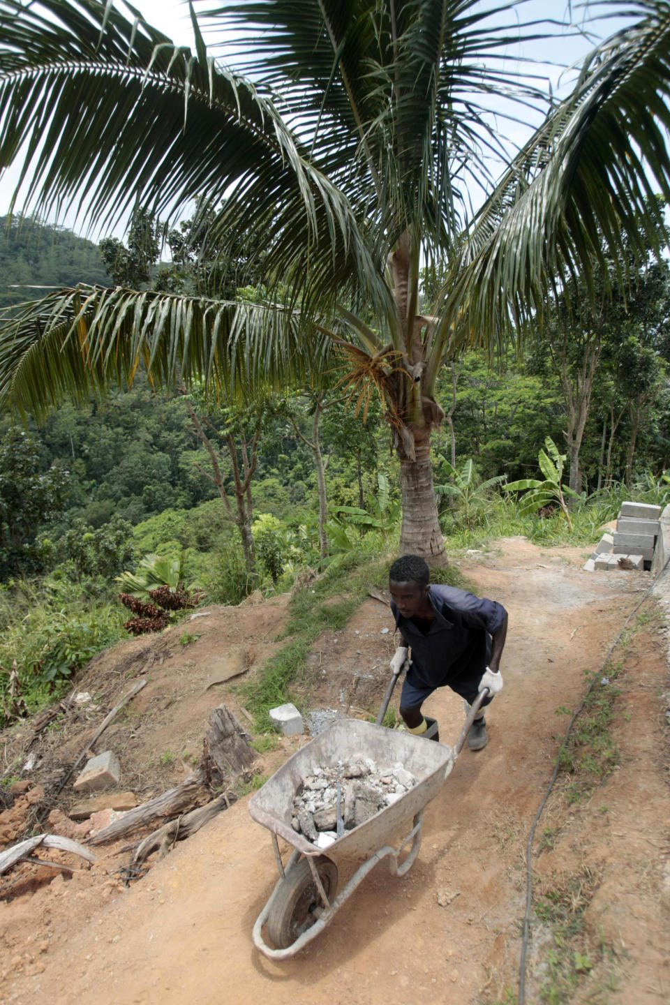 A Somali inmates, detained in an anti-piracy operation conducted by the Seychelles Coast Guard, works at the incarceration block in Montagne Posee near Victoria, Seychelles, Friday, March 2, 2012. (AP Photo/Gregorio Borgia)