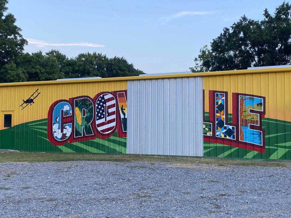 The newly-painted mural looks incomplete after a car ran into the building on which it was painted Friday.