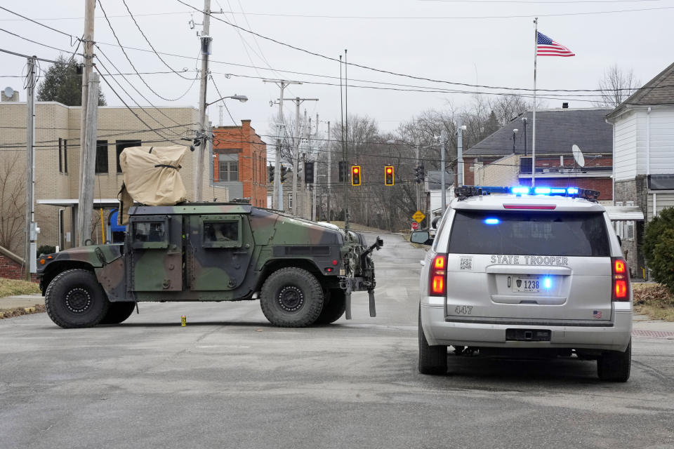 A road in East Palestine, Ohio, is blocked after residents within a one-mile radius surrounding the site of a Norfolk Southern train derailment were forced to evacuate for fear of an explosion, Monday, Feb. 6, 2023. (AP Photo/Gene J. Puskar)