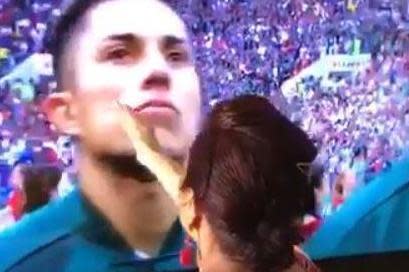 The footage shows the grandmother blessing each member of the Mexico team as they sing for the national anthem