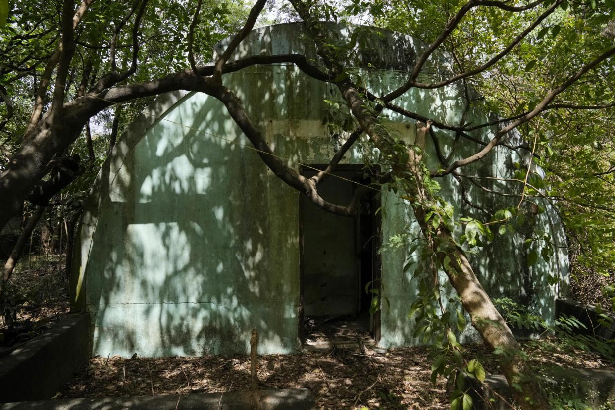 Trees and wild vines grow beside an abandoned concrete structure called "Quonset huts" formerly used as barracks for U.S. Marines in what used to be America's largest overseas naval base at the Subic Bay Freeport Zone, Zambales province, northwest of Manila, Philippines on Monday Feb. 6, 2023. The U.S. has been rebuilding its military might in the Philippines after more than 30 years and reinforcing an arc of military alliances in Asia in a starkly different post-Cold War era when the perceived new regional threat is an increasingly belligerent China. (AP Photo/Aaron Favila)