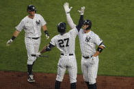 New York Yankees' Aaron Judge, right, celebrates his two-run home run with Giancarlo Stanton (27), center, and DJ LeMahieu during the third inning of the baseball game against the Boston Red Sox at Yankee Stadium, Friday, July 31, 2020, in New York. (AP Photo/Seth Wenig)