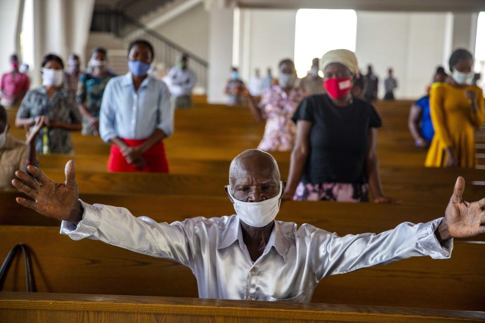 Worshipers attend Mass at the Cathedral of Port-au-Prince, marking the reopening of places of worship since the beginning in March of the COVID-19 lockdown, in Port-au-Prince, Haiti, Sunday, July 12, 2020. By order of President Jovenel Moise and the recommendation of Haiti's health authorities, churches reopened after having been closed for months due to social distancing rules to curb the spread of the pandemic. (AP Photo/Dieu Nalio Chery)